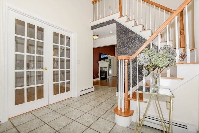 foyer entrance featuring tile patterned floors, french doors, and a baseboard radiator