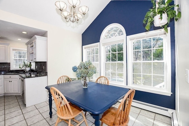 tiled dining space featuring lofted ceiling, a baseboard radiator, and a chandelier