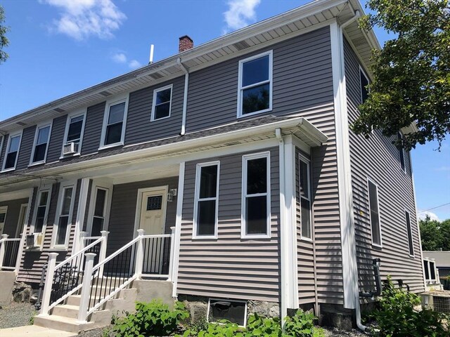 view of front of home with central AC unit and a porch