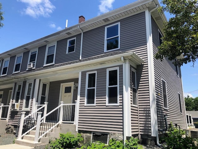 28-32 Calvary St, Waltham, MA 02453 - view of front of property with a porch, a chimney, and central air condition unit