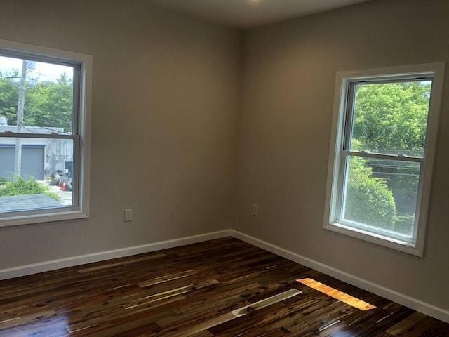 28-32 Calvary St, Waltham, MA 02453 - empty room featuring baseboards and dark wood finished floors