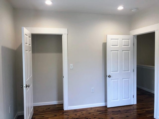 28-32 Calvary St, Waltham, MA 02453 - unfurnished bedroom with a closet, baseboards, dark wood-style flooring, and recessed lighting