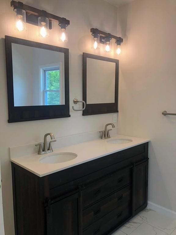 28-32 Calvary St, Waltham, MA 02453 - bathroom with double vanity, marble finish floor, baseboards, and a sink