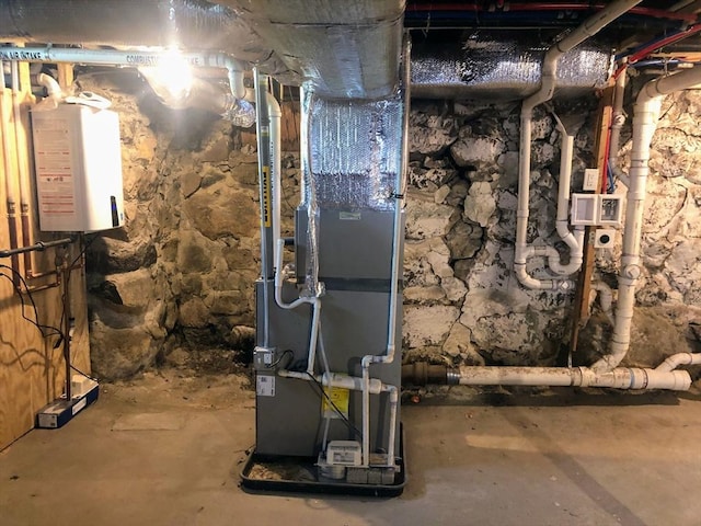 28-32 Calvary St, Waltham, MA 02453 - utility room featuring water heater and heating unit
