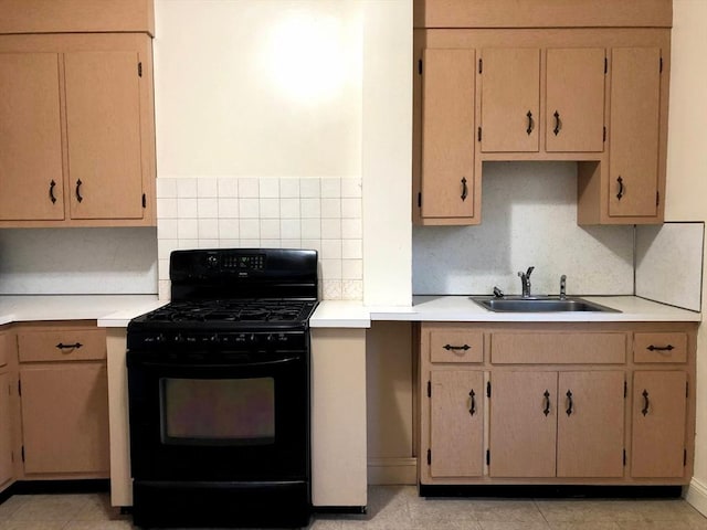 28-32 Calvary St, Waltham, MA 02453 - kitchen with light tile patterned floors, tasteful backsplash, light countertops, black range with gas cooktop, and a sink