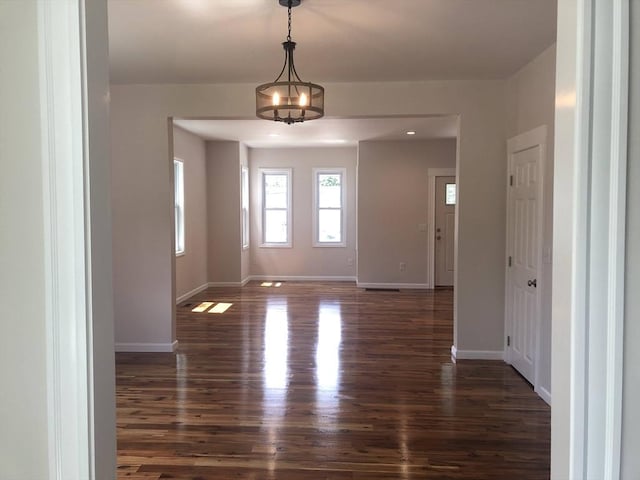28-32 Calvary St, Waltham, MA 02453 - unfurnished room with an inviting chandelier, baseboards, and dark wood-style flooring