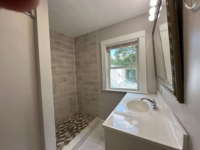 bathroom featuring vanity and tiled shower