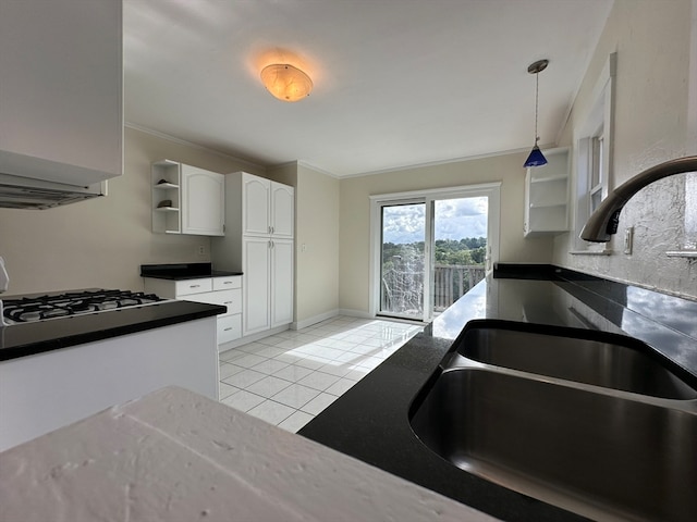 kitchen featuring white cabinetry, light tile patterned flooring, pendant lighting, crown molding, and sink