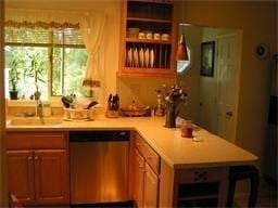 bar featuring stainless steel dishwasher and a sink