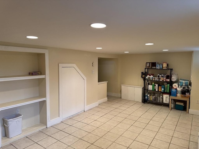 basement featuring recessed lighting, light tile patterned floors, and baseboards