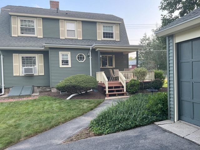 view of front of property with cooling unit, a front lawn, a shingled roof, and covered porch
