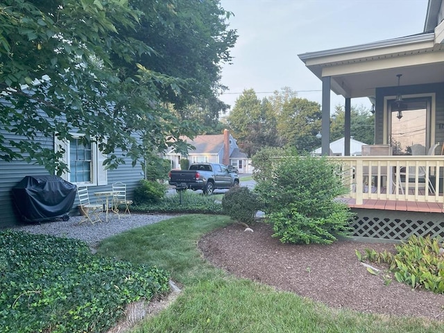 view of yard featuring covered porch