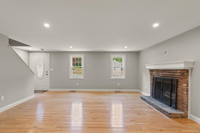 7 Chestnut St, West Newbury, MA 01985 - unfurnished living room with light wood-style flooring, a brick fireplace, baseboards, and recessed lighting
