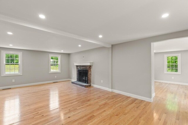 7 Chestnut St, West Newbury, MA 01985 - unfurnished living room with light wood-style flooring, a fireplace, recessed lighting, and baseboards