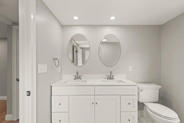 7 Chestnut St, West Newbury, MA 01985 - bathroom with double vanity, toilet, baseboards, and recessed lighting