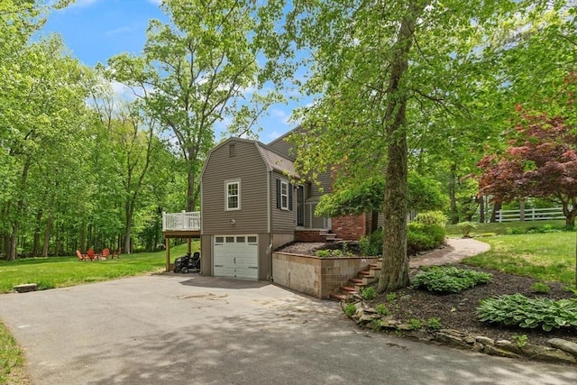 7 Chestnut St, West Newbury, MA 01985 - view of property exterior featuring driveway, stairway, a garage, a lawn, and a gambrel roof