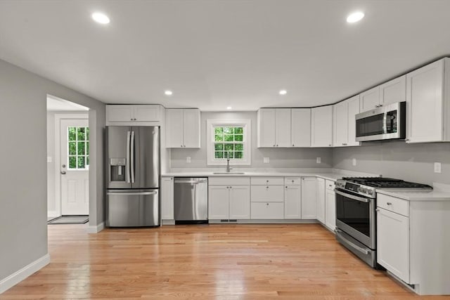 7 Chestnut St, West Newbury, MA 01985 - kitchen with appliances with stainless steel finishes, a sink, white cabinetry, and recessed lighting