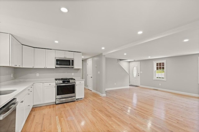 7 Chestnut St, West Newbury, MA 01985 - kitchen featuring appliances with stainless steel finishes, light wood-type flooring, light countertops, white cabinets, and recessed lighting