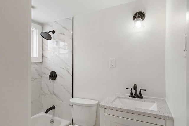 full bathroom featuring vanity, tiled shower / bath combo, and toilet