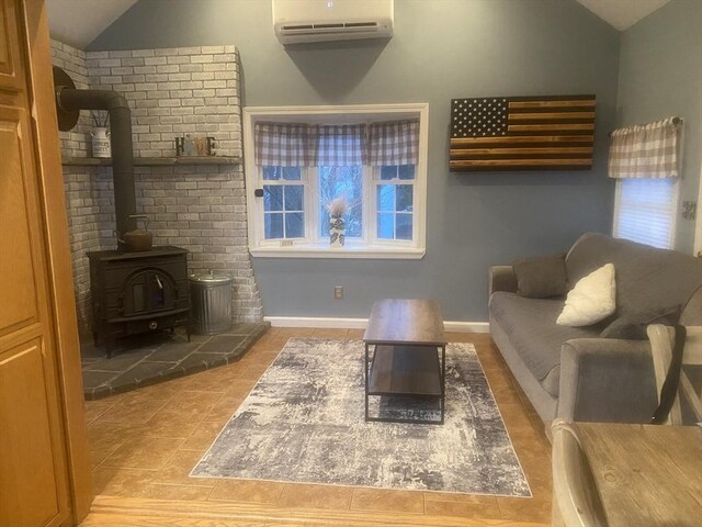 169 Green St, Gardner, MA 01440 - tiled living area with vaulted ceiling, an AC wall unit, a wood stove, and baseboards