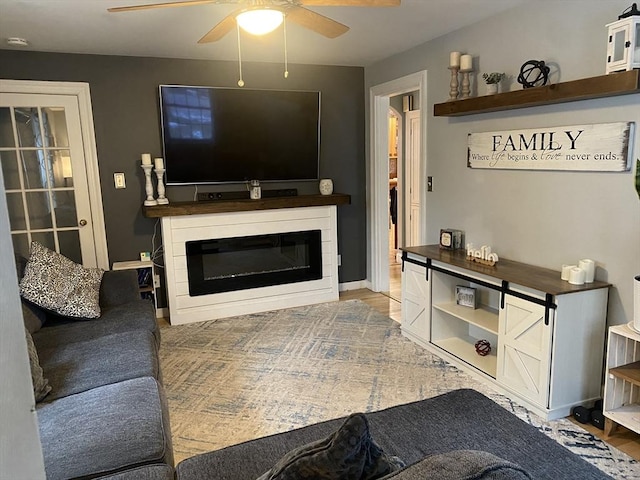 169 Green St, Gardner, MA 01440 - living area with a ceiling fan, a glass covered fireplace, and baseboards