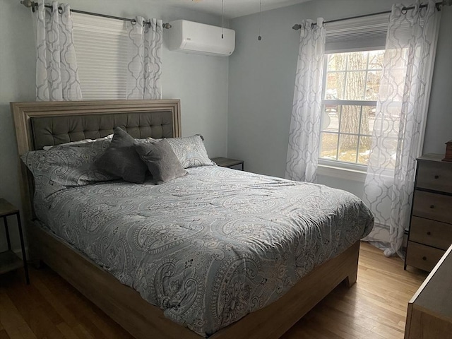 169 Green St, Gardner, MA 01440 - bedroom featuring a wall unit AC and wood finished floors