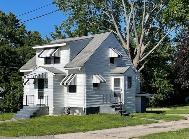 912 Pleasant St, Somerset, MA 02726 - view of front of property featuring a shingled roof and a front yard