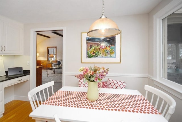 dining room with light wood-style floors and built in desk