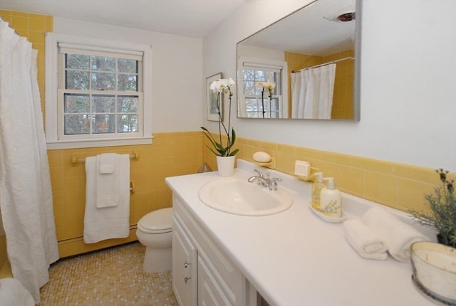 bathroom featuring toilet, a wainscoted wall, a shower with shower curtain, vanity, and tile walls