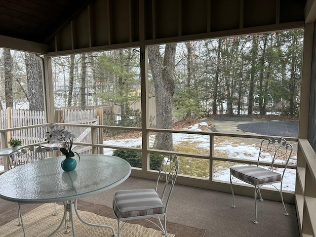 sunroom featuring lofted ceiling