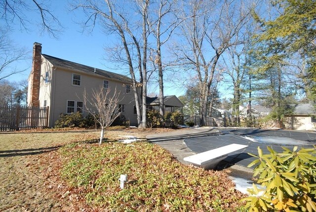 exterior space with a chimney and fence