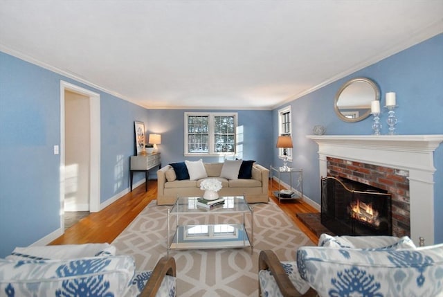 living area with a fireplace, baseboards, and wood finished floors