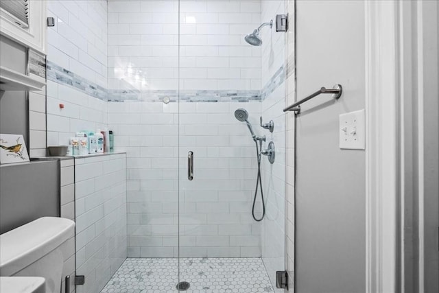 full bathroom featuring toilet and a stall shower