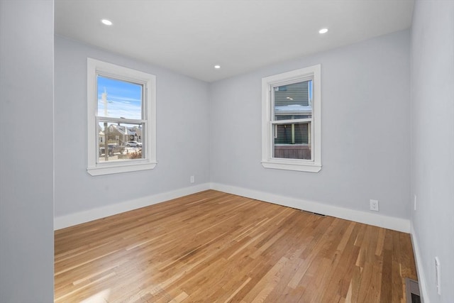 spare room featuring light hardwood / wood-style floors