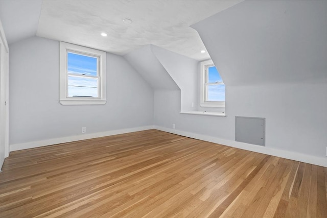 bonus room featuring light hardwood / wood-style flooring, a wealth of natural light, and vaulted ceiling