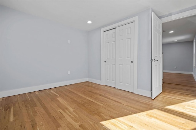 unfurnished bedroom with light hardwood / wood-style floors and a closet