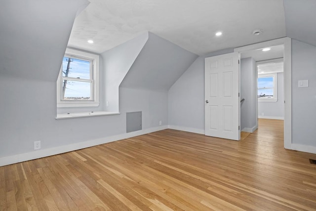 bonus room featuring vaulted ceiling and light wood-type flooring