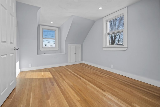 additional living space with lofted ceiling and light wood-type flooring