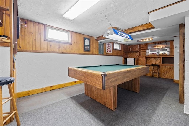 rec room featuring indoor bar, pool table, dark carpet, and wood walls