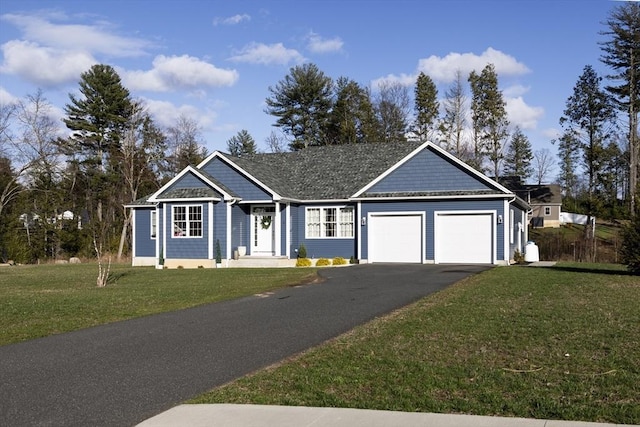 single story home with an attached garage, driveway, and a front yard