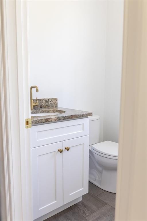 bathroom featuring vanity and toilet