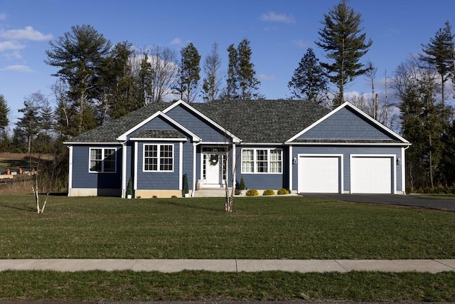 single story home featuring an attached garage, a front lawn, and aphalt driveway