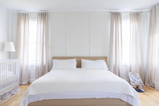 bedroom featuring a decorative wall and multiple windows