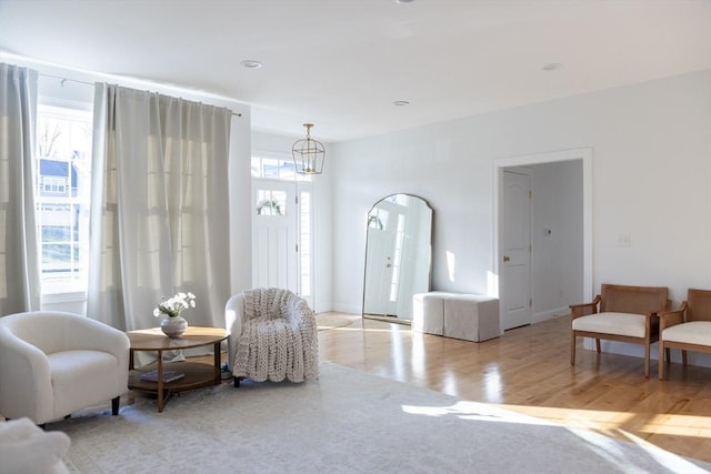 sitting room with an inviting chandelier and wood finished floors