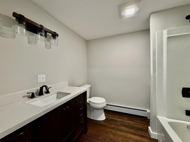 full bathroom with a baseboard heating unit, vanity, toilet, hardwood / wood-style flooring, and  shower combination