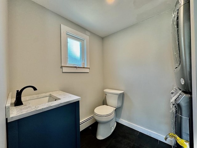 bathroom with toilet, vanity, and a baseboard radiator