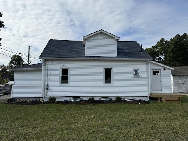 rear view of property with a yard