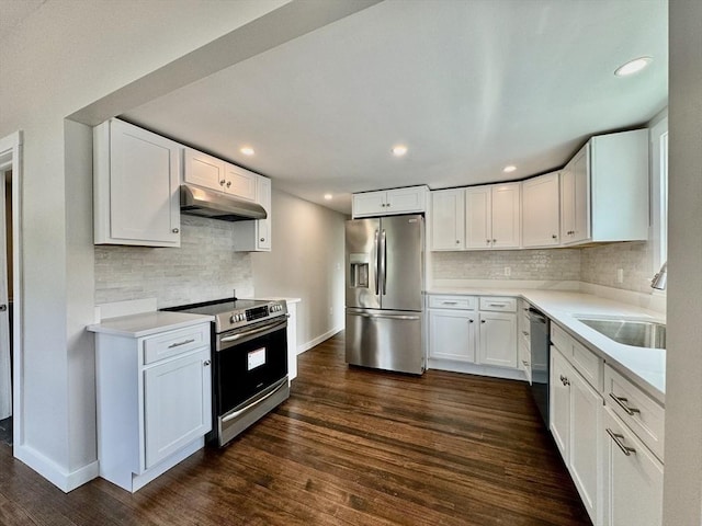 kitchen featuring dark wood-type flooring, white cabinets, appliances with stainless steel finishes, and sink