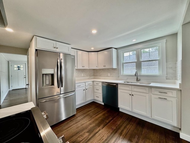 kitchen featuring appliances with stainless steel finishes, backsplash, white cabinets, and sink