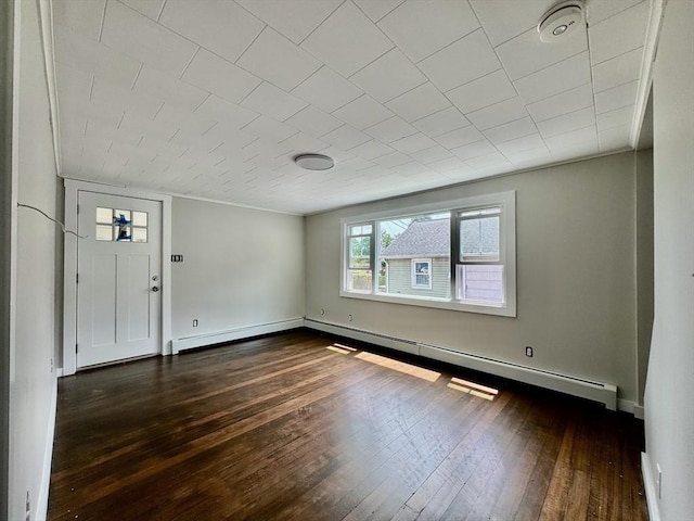 foyer entrance with a baseboard heating unit and dark hardwood / wood-style flooring